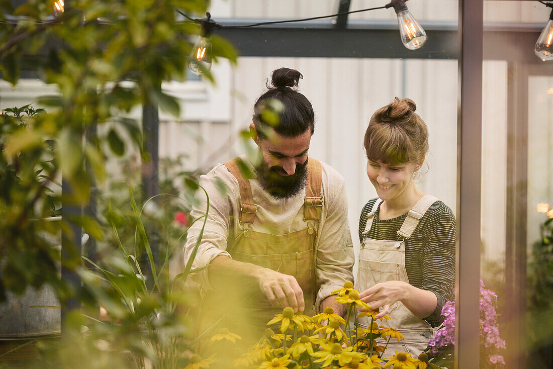 Smiling couple in greenhouse