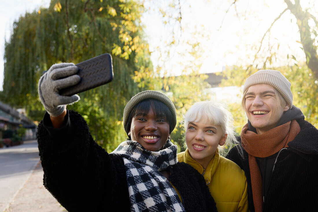 Smiling young friends taking selfie