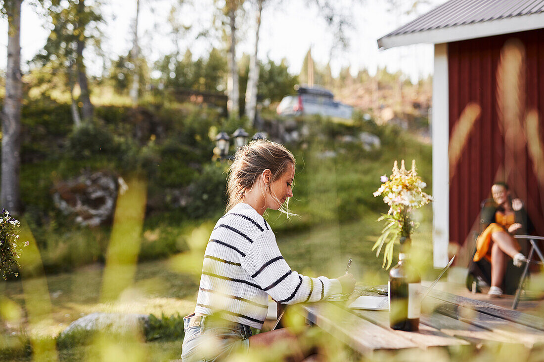 Smiling woman taking notes