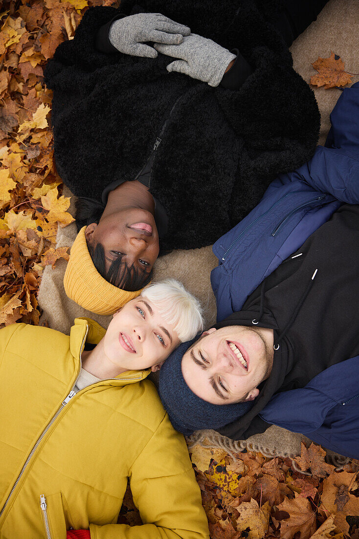 Smiling friends lying together