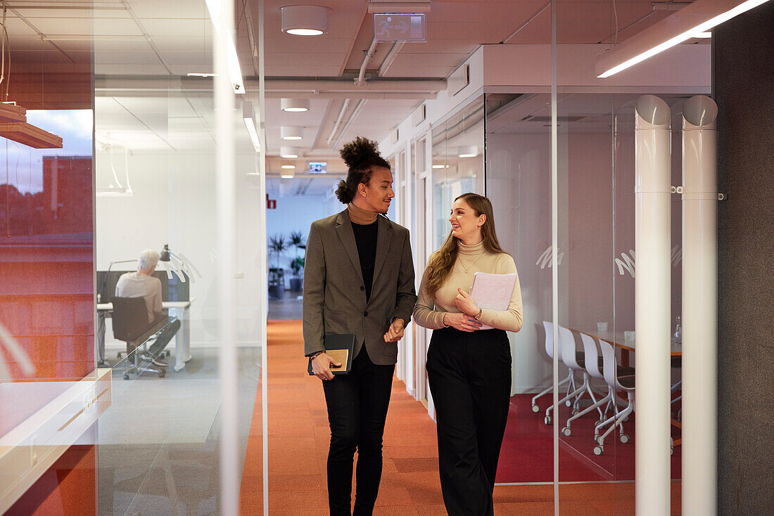 Business people walking in office corridor