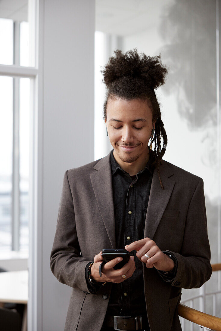 Young businessman talking on phone in office