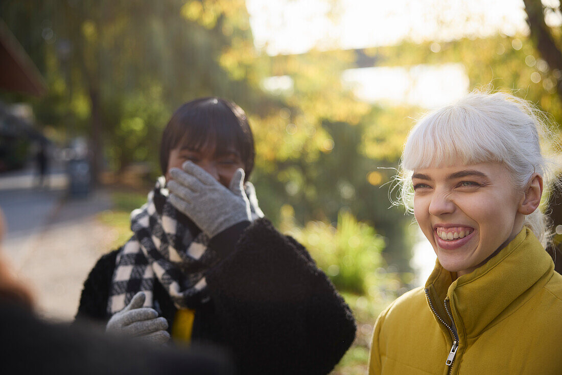 Smiling young friends talking outdoors