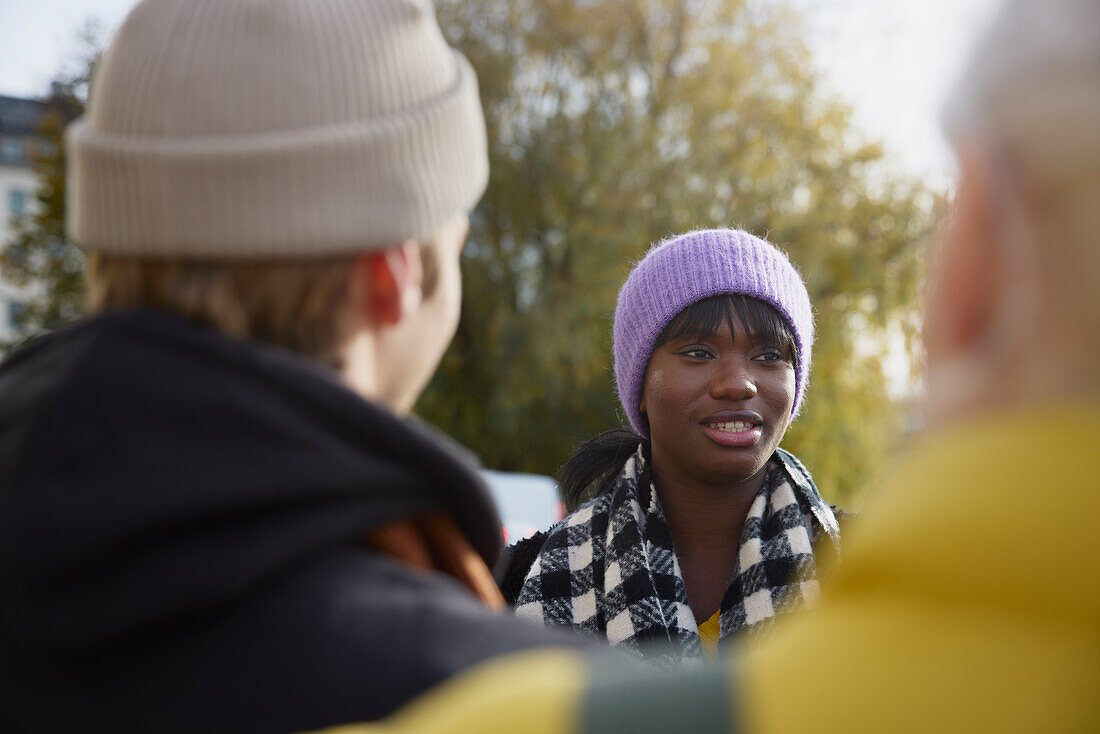 Smiling woman talking to friends