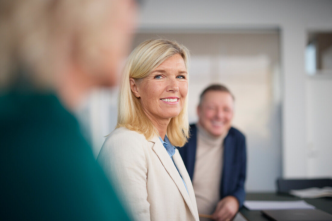 Smiling woman at business meeting