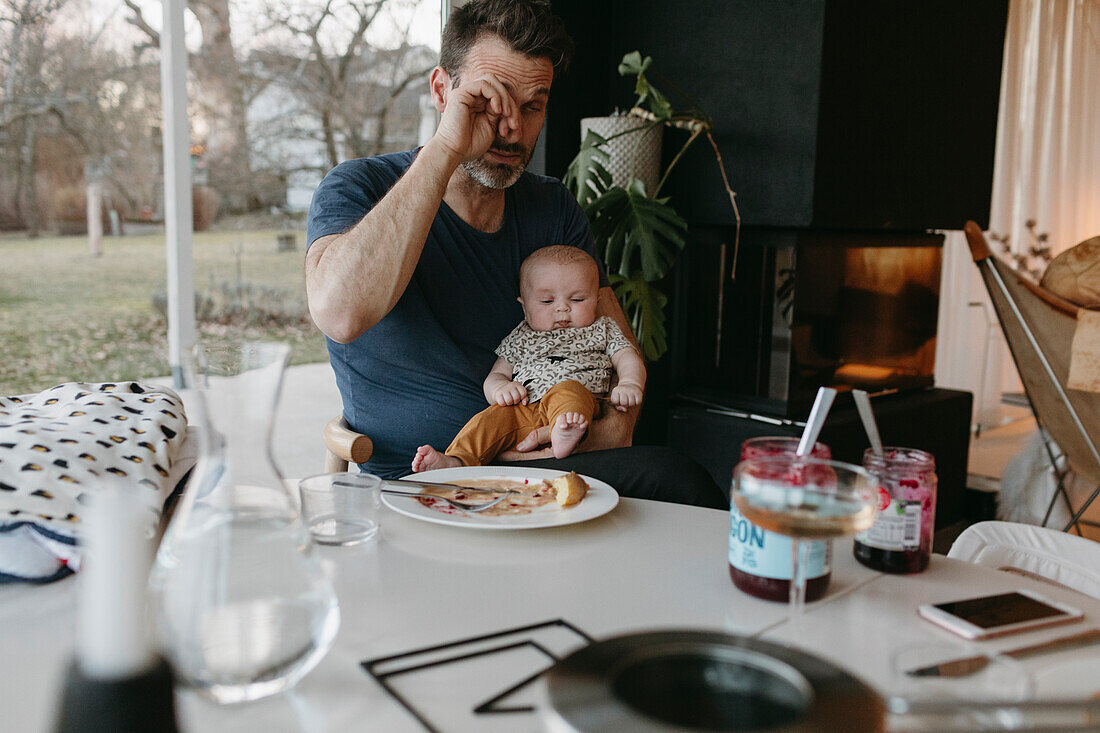 Father sitting at table with baby