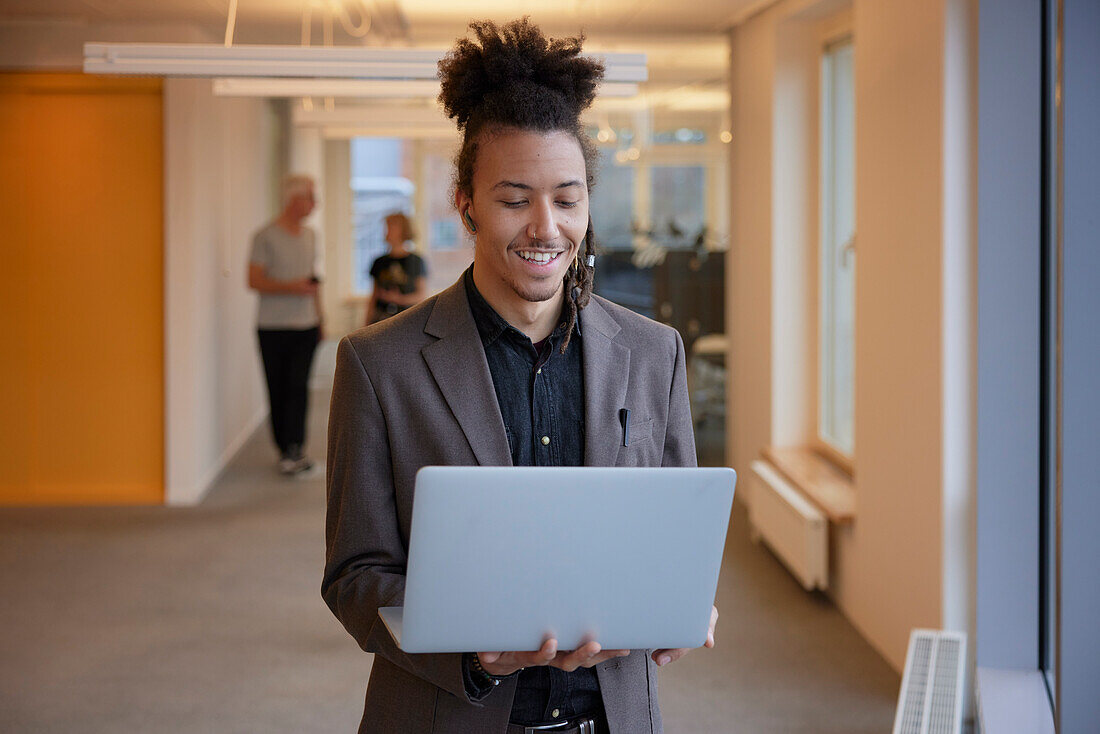 Man in office using laptop