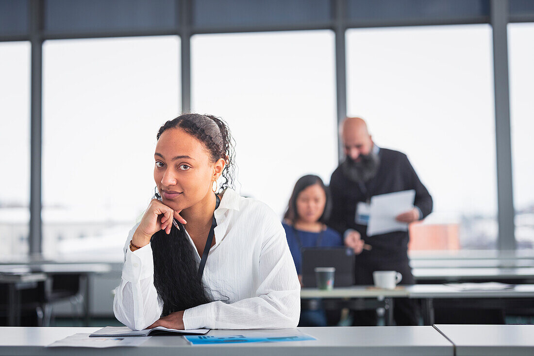 Portrait of young businesswoman sitting at desk