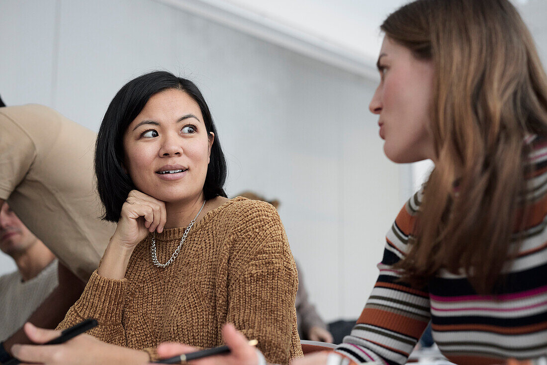 Adult female students talking in class