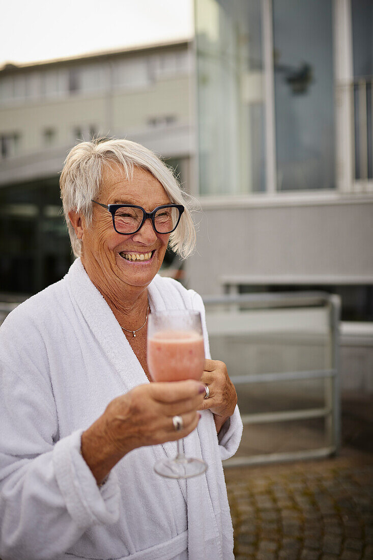 Senior woman holding smoothie