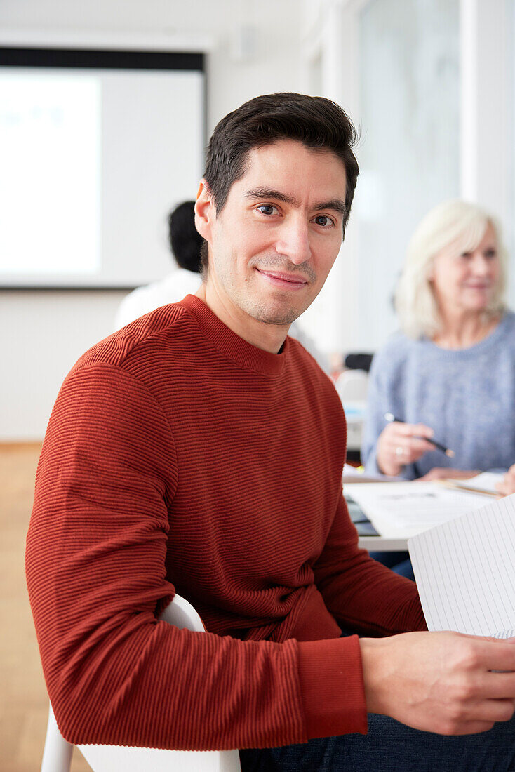 Smiling man sitting at workshop