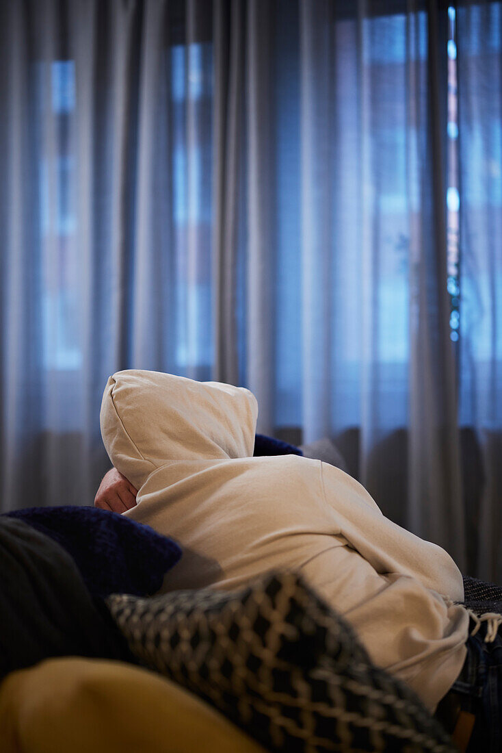 Man resting on sofa