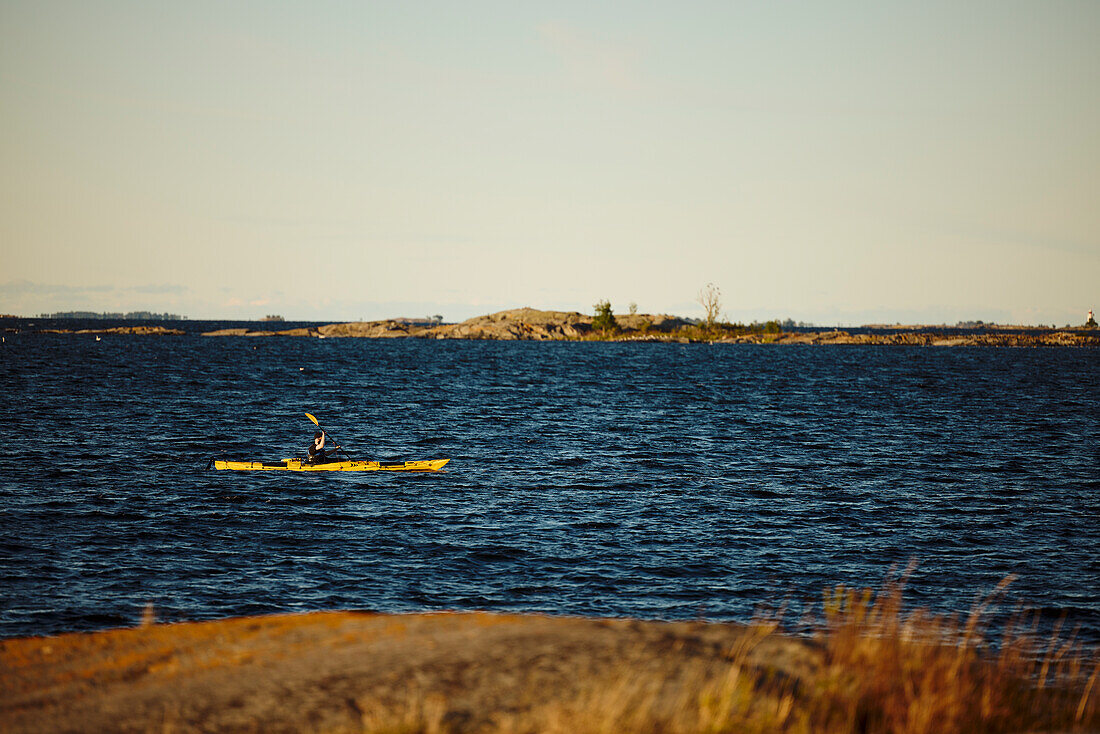 Person kayaking on sunny autumn day
