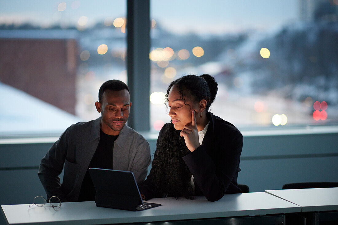 Colleagues working late in office