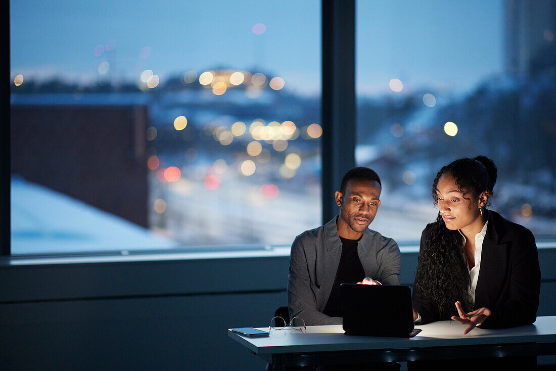 Colleagues working late in office