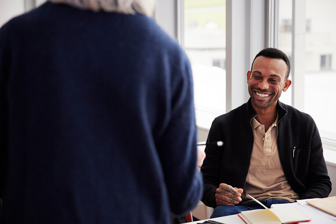 Smiling man sitting at workshop