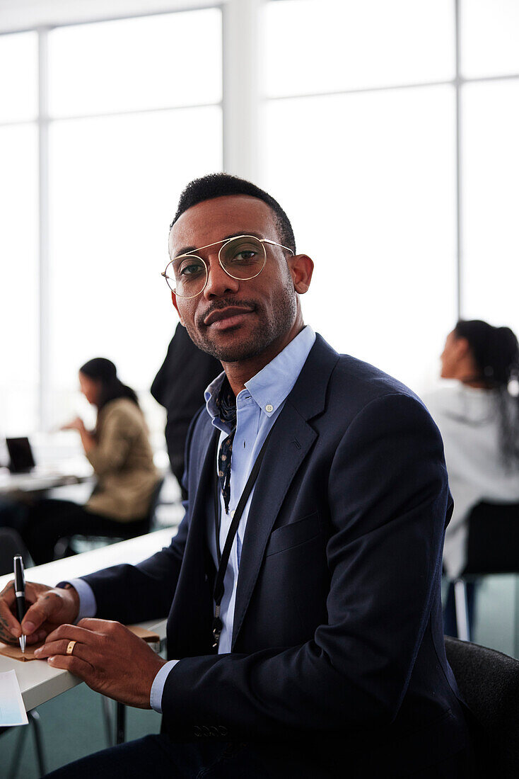 Portrait of businessman sitting at desk