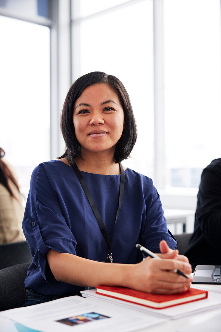 Portrait of young businesswoman sitting at desk