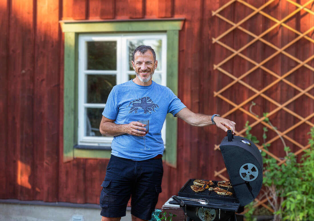 Smiling man having barbecue
