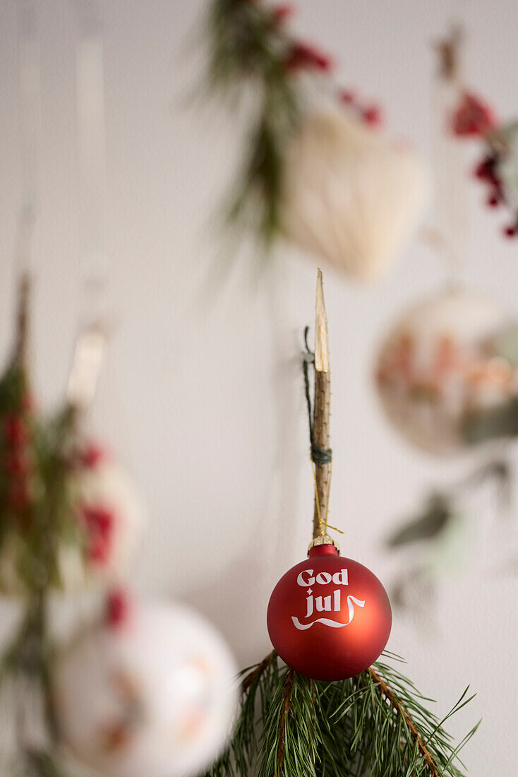 Christmas bauble hanging on branch