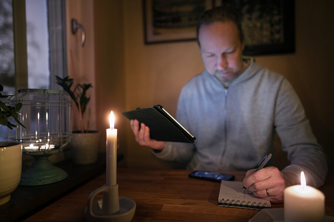 Man working without electric light