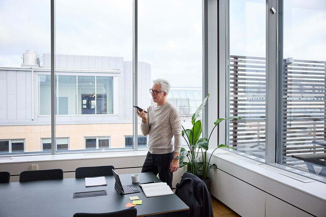 Smiling businessman in boardroom