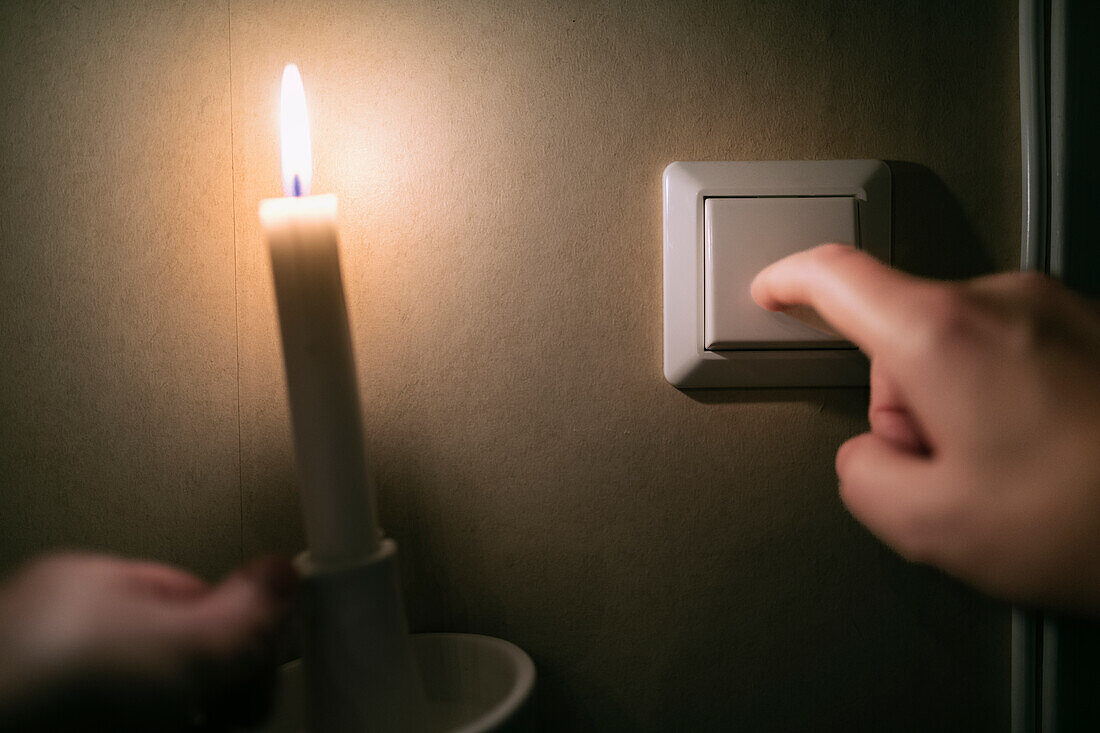 Person switching off electric light