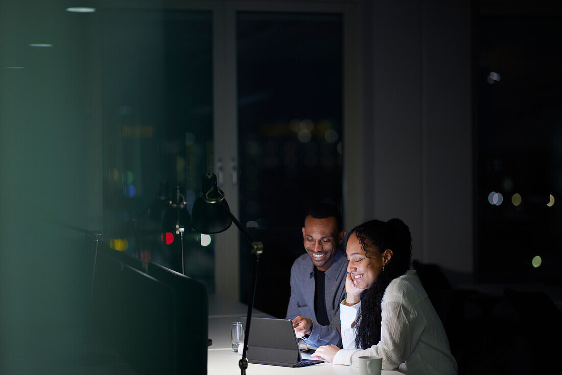 Man and woman working late in office