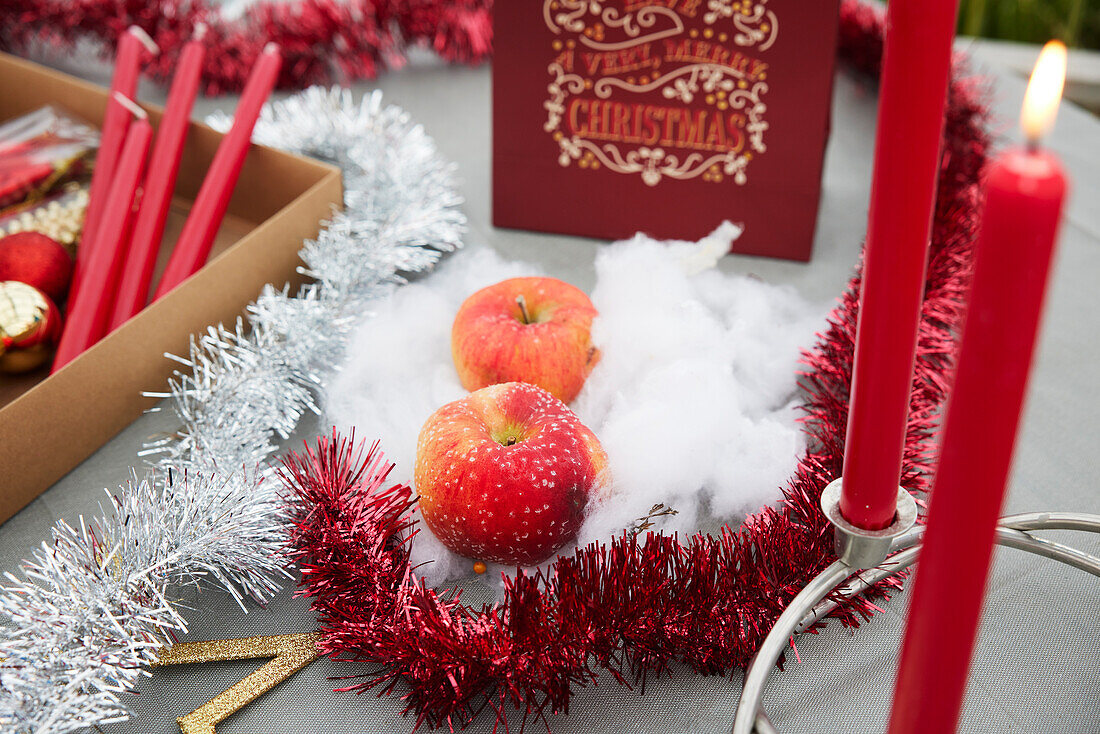 Christmas ornaments, apples, and candles