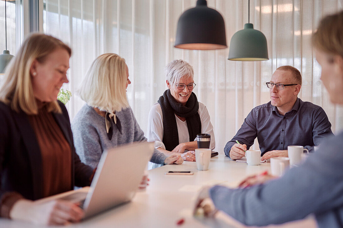 People taking during business meeting