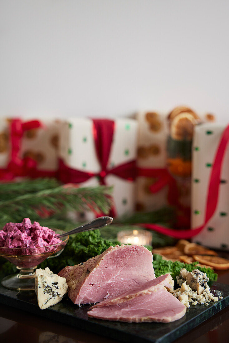 Weihnachtsschinken und Geschenke auf dem Tisch