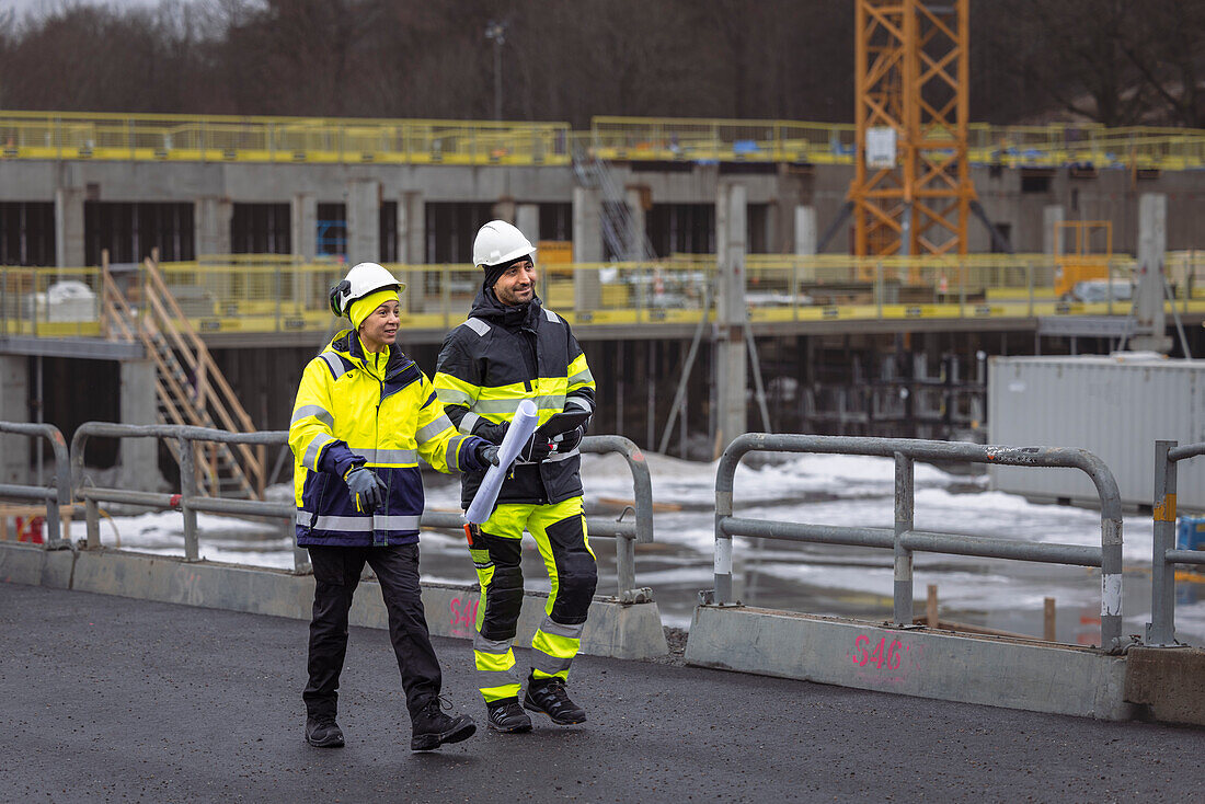 Engineers talking at building site