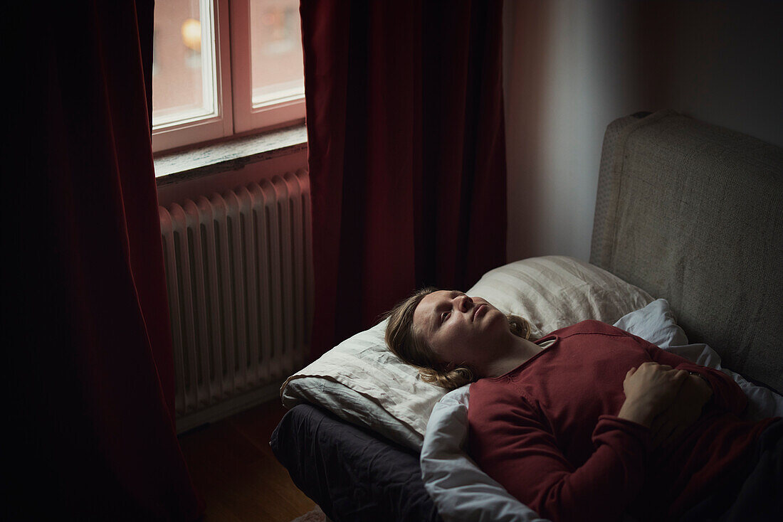 View of man lying on bed