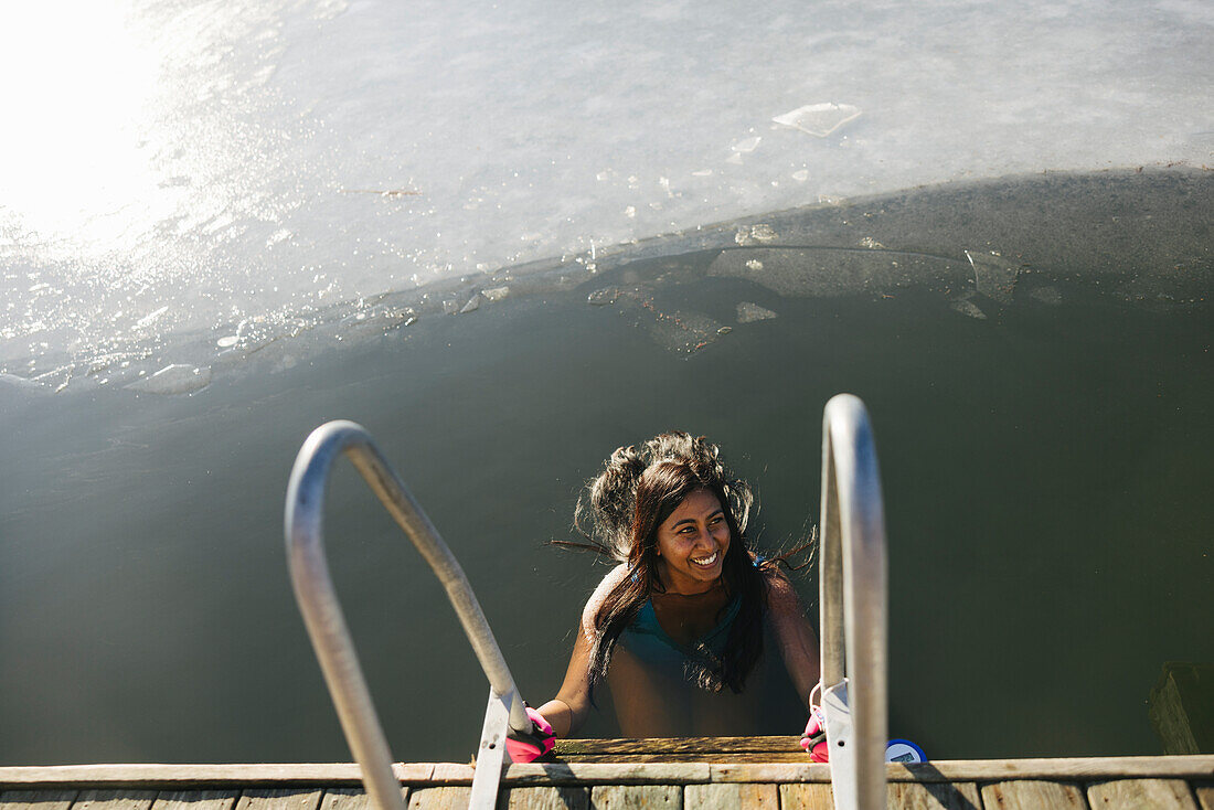 Woman swimming in lake at winter