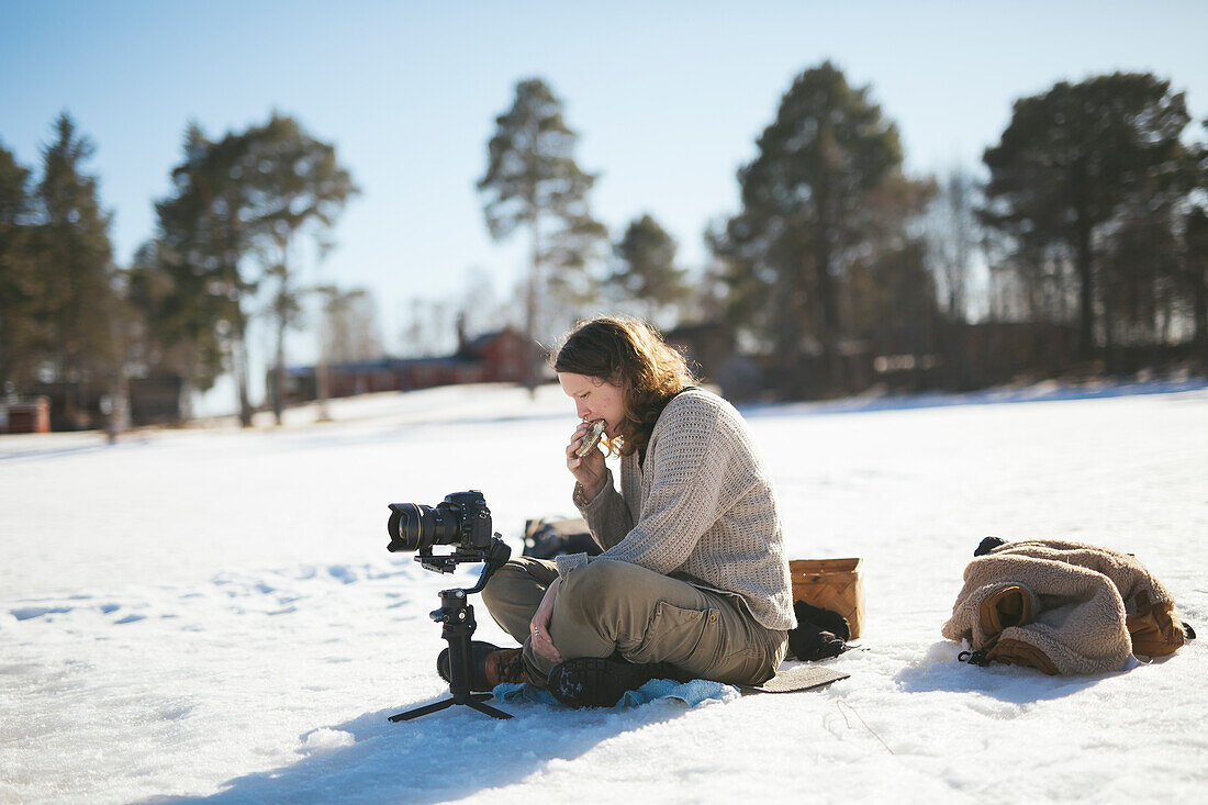 Photographer sitting on snow and relaxing