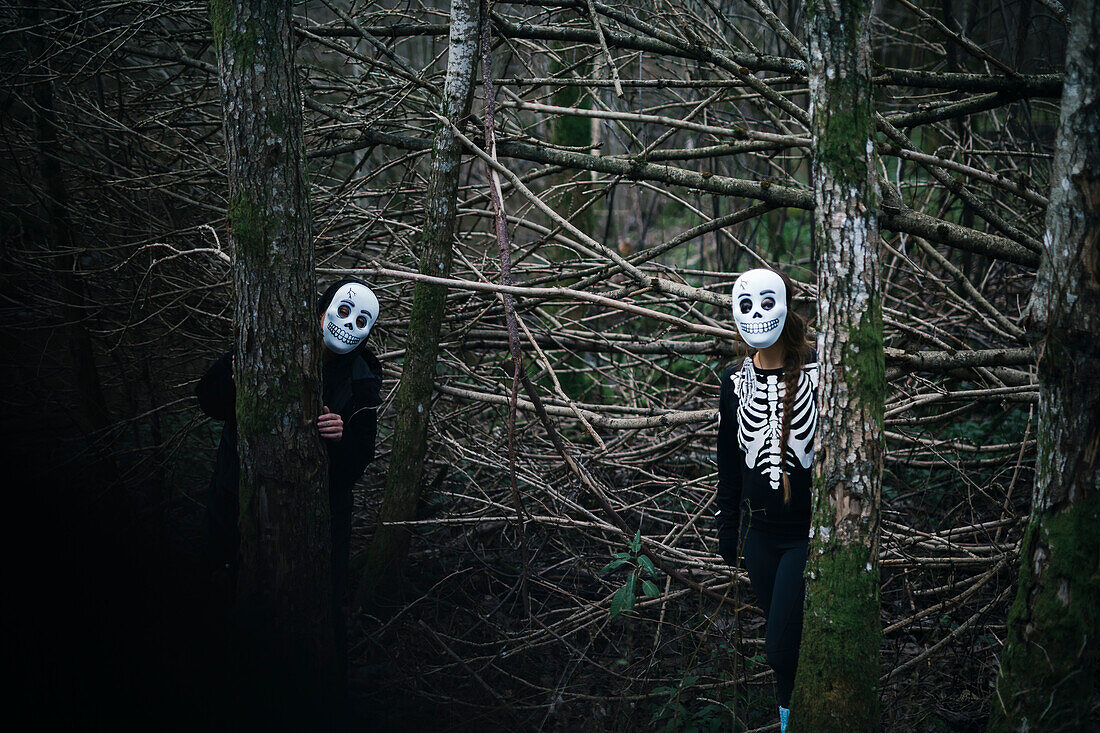 Two people wearing Halloween costume in forest