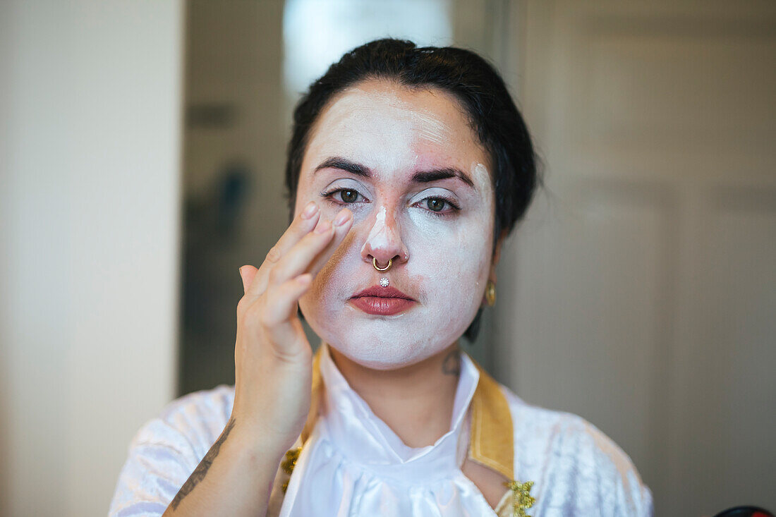 Woman painting face for Halloween