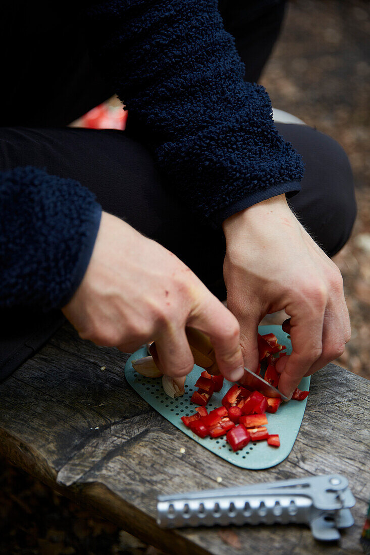 Man's hands cutting pepper outdoors