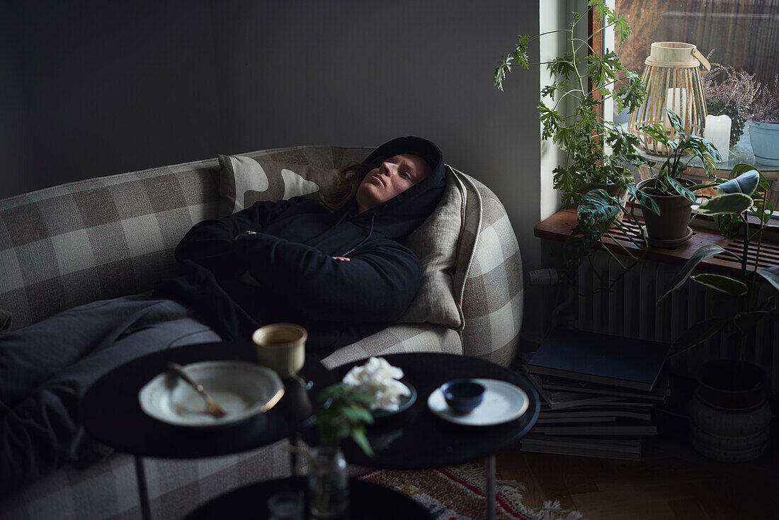 Sad man facing depression lying in bed