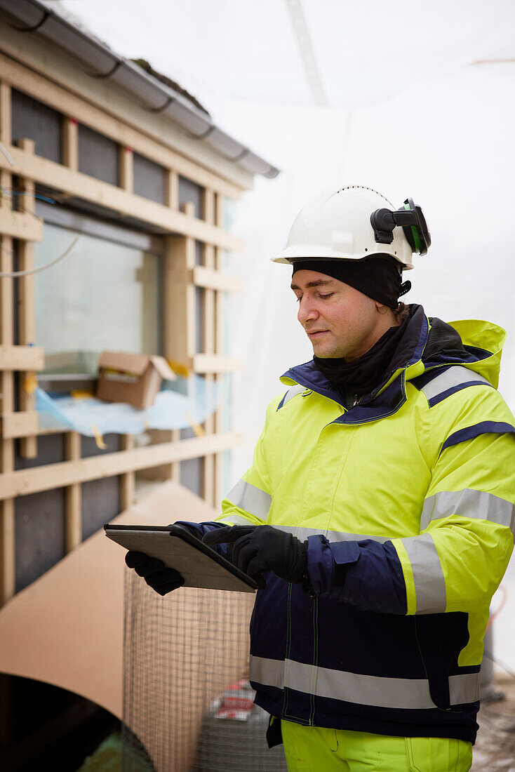 Ingenieurin mit digitalem Tablet auf der Baustelle