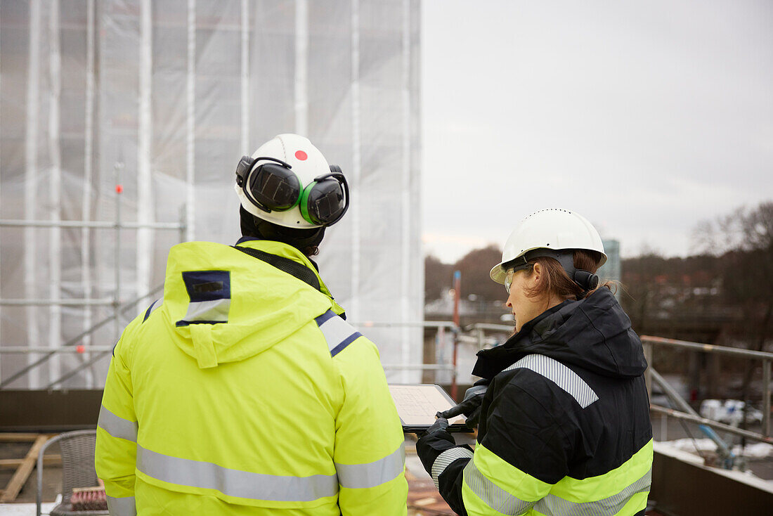 Engineers talking at building site