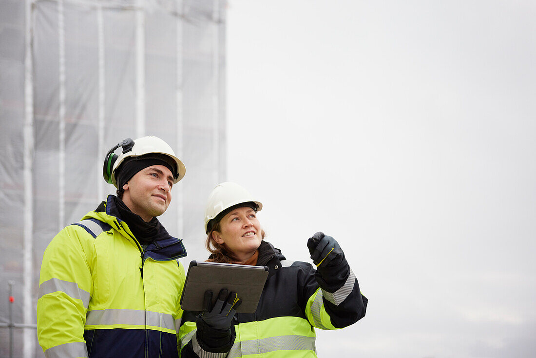 Engineers talking at building site