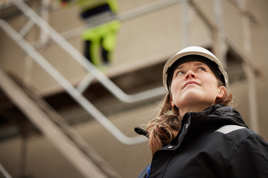 Female engineer standing at building site