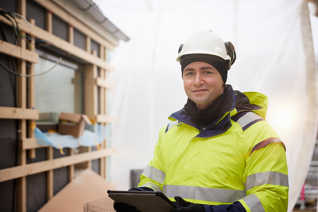 Engineer using digital tablet at building site