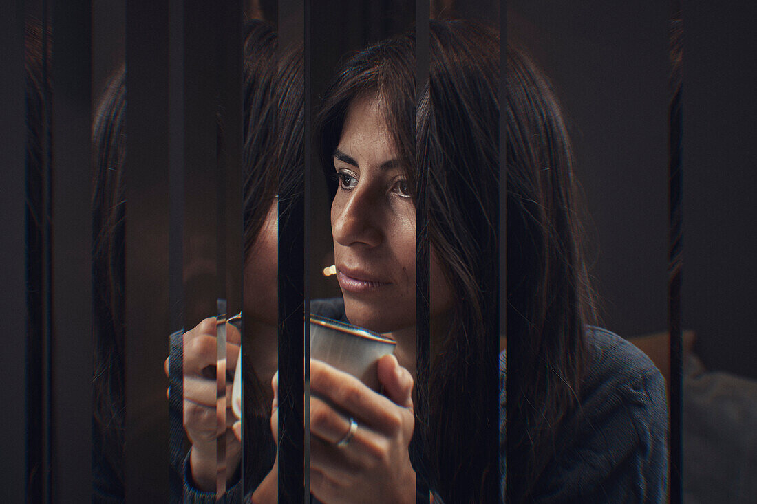 Digital composite of pensive woman drinking tea