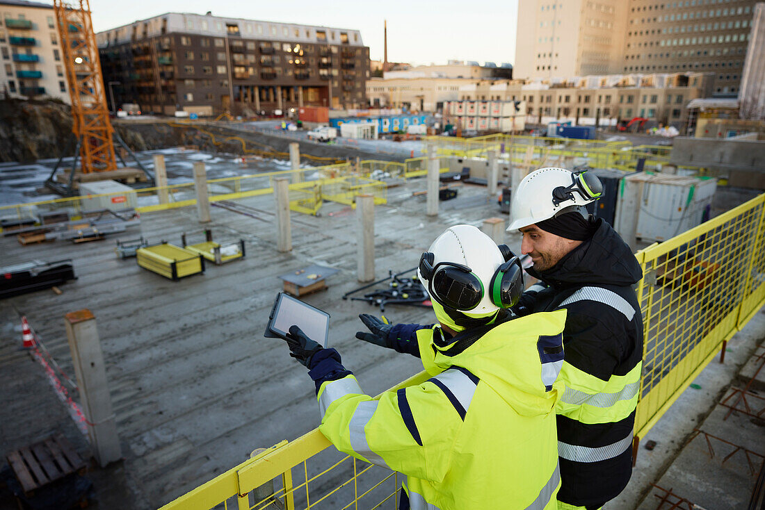 Two engineers working at construction site