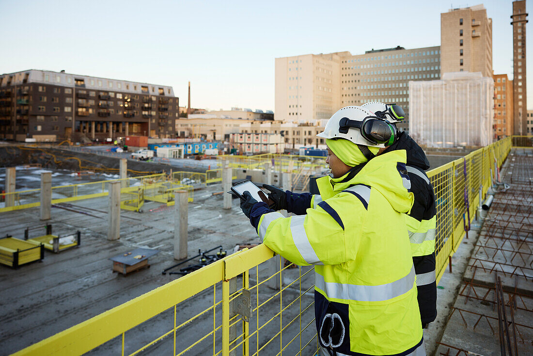 Two engineers working at construction site