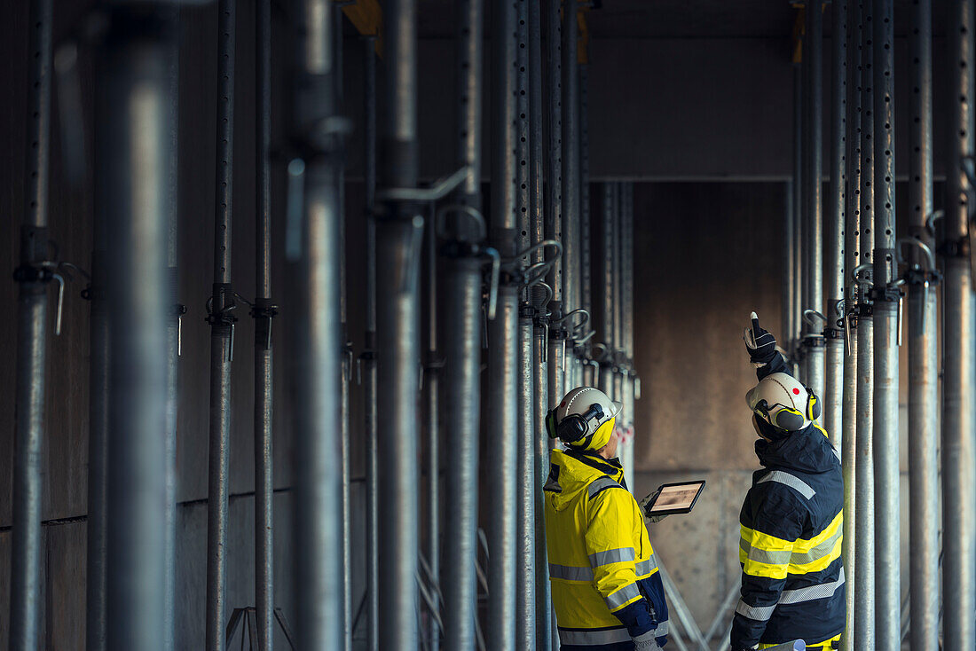 Engineers talking at building site