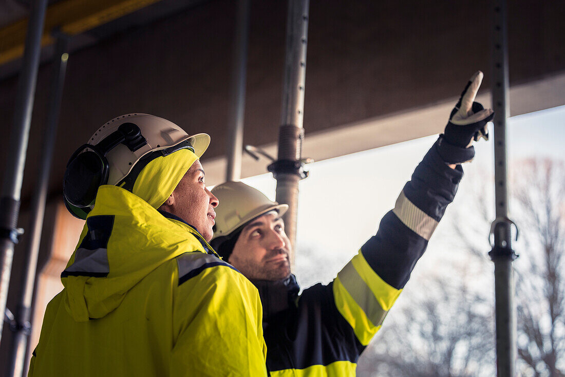 Engineers talking at building site