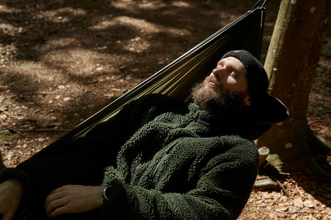 Man sleeping on hammock, high angle view